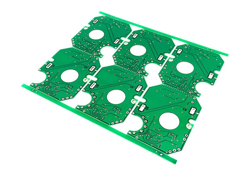 Four identical circuit boards laid out in a row on a white surface.
