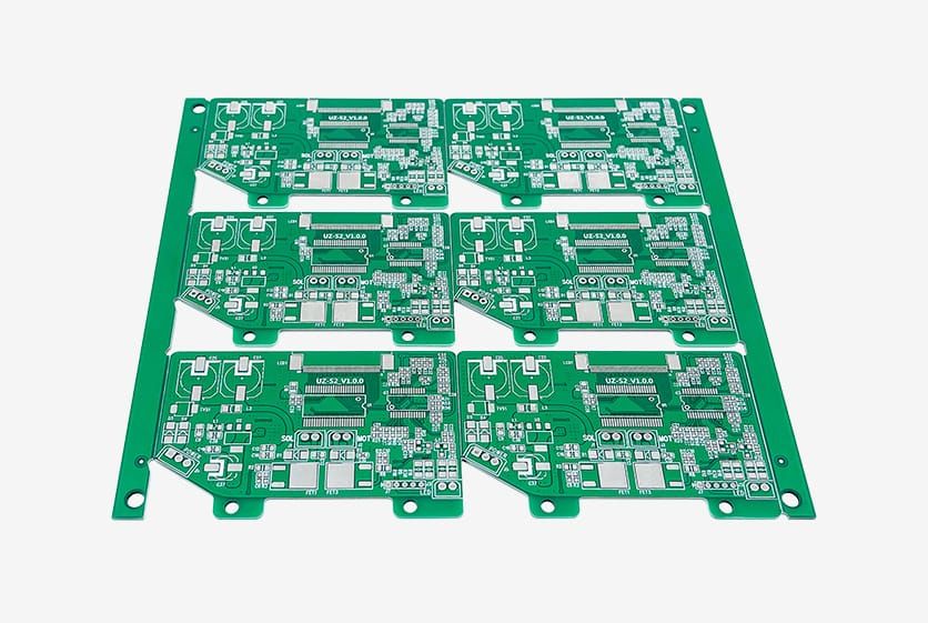 Panel array of identical green circuit boards after routing, laid out on a light background.